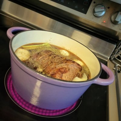 Purple five quart Dutch oven with pot roast for faux Xmas Day supper.
