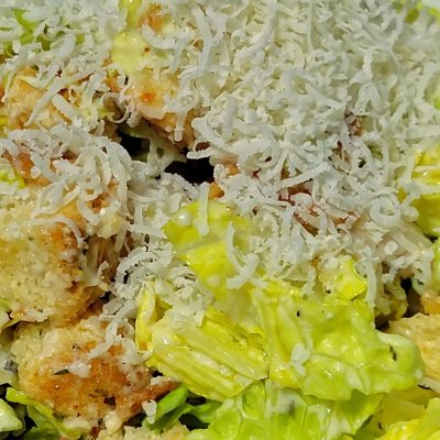 Valentine's Day supper. Caesar salad with chicken and bacon bits alongside homemade tagliatelle in a basil pesto.