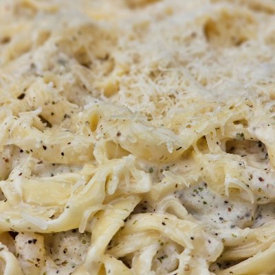 Scratch made linguini noodles in a white wine and cream sauce with some grated parmesan cheese.