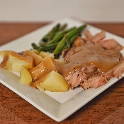 Beef pot roast, potatoes,  pan-fried green beans, and gravy.
